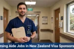 Nursing Aide Jobs in New Zealand male nursing aide holding a care file in a New Zealand aged-care facility corridor